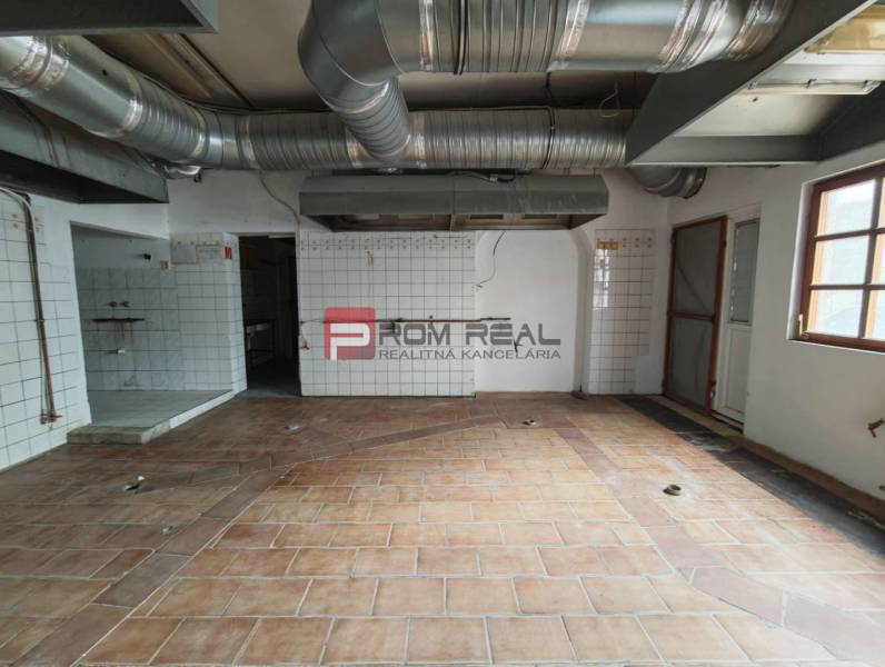 Commercial premises with tiled flooring and ventilation.
