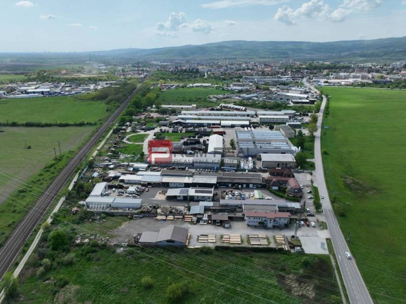 Aerial view of commercial premises on Šenkvická Road in Pezinok surrounded by nature.