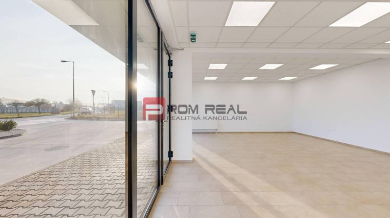 Spacious commercial spaces with large windows and modern lighting.