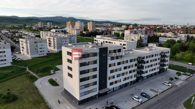 Commercial premises on Obchodná Street in Pezinok, surrounded by apartment buildings and greenery.