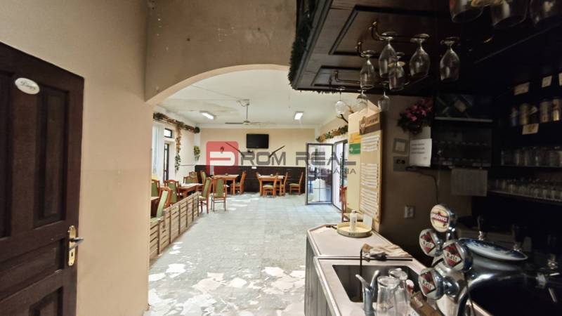 Interior of gastro spaces with furniture and a bar, dark wood, pleasant atmosphere.