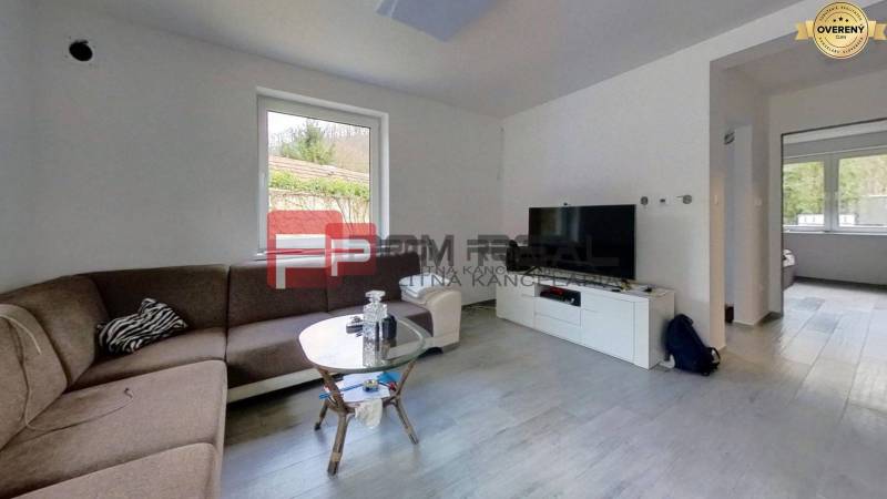 Living room with a corner sofa, coffee table, and television in a family house.