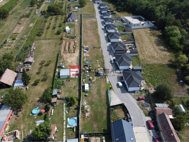 Aerial view of residential plots in Štefanová, adjacent to a row of houses.