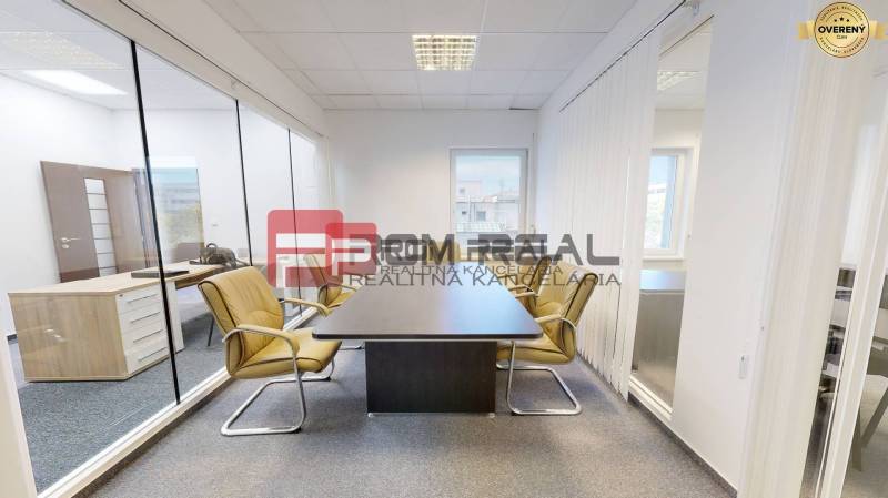 Modern offices with glass partitions, light furniture, and windows.