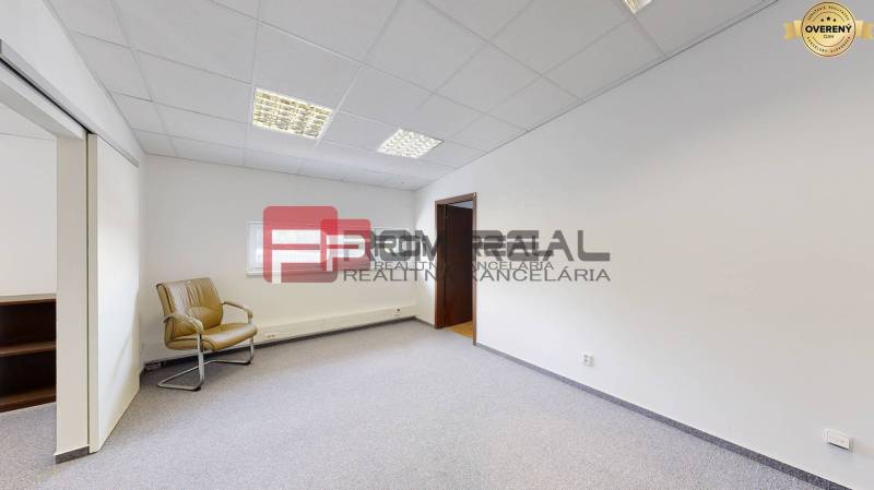 Spacious offices with one chair, white walls, and carpeted floor.