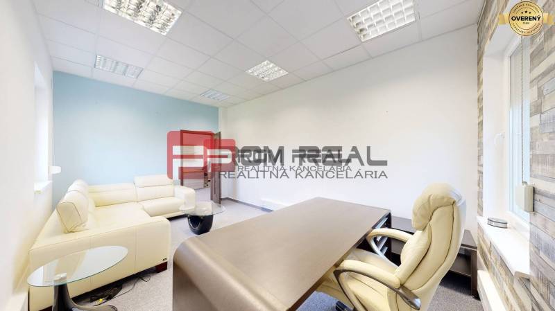 Offices with a beige sofa, wooden desk, and office chair.