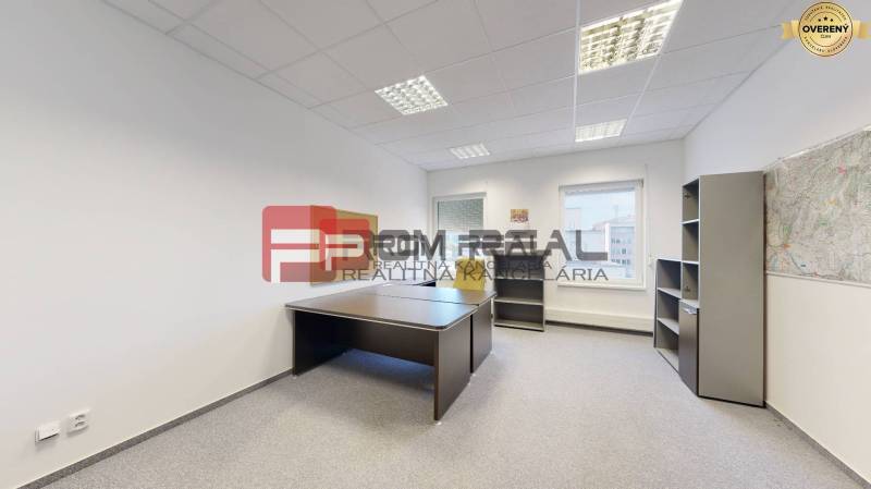 Offices with a desk and a shelving cabinet, light walls and a window with a view.