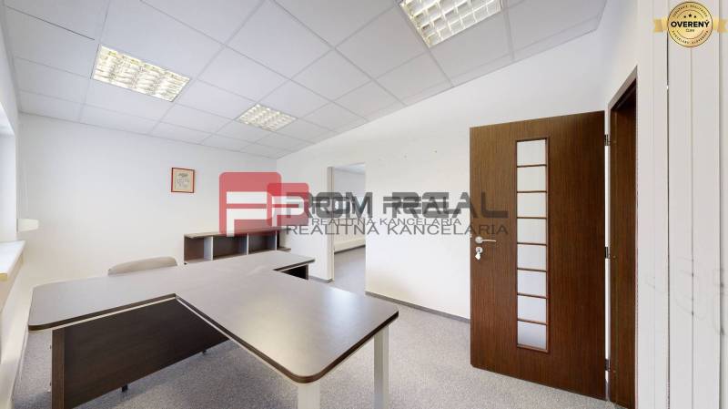 Offices with a desk and chairs, white walls, and a light ceiling.