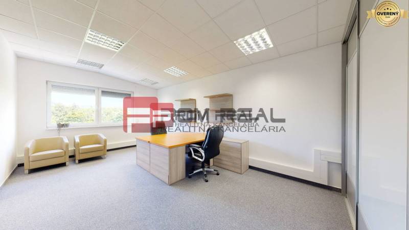 Office interior with a desk, chairs, and a window, bright and spacious furnishings.