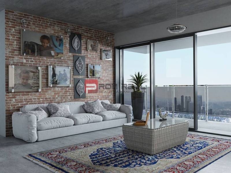 Living room of a 3-room apartment with a brick wall, sofa, carpets, and a balcony with a view.