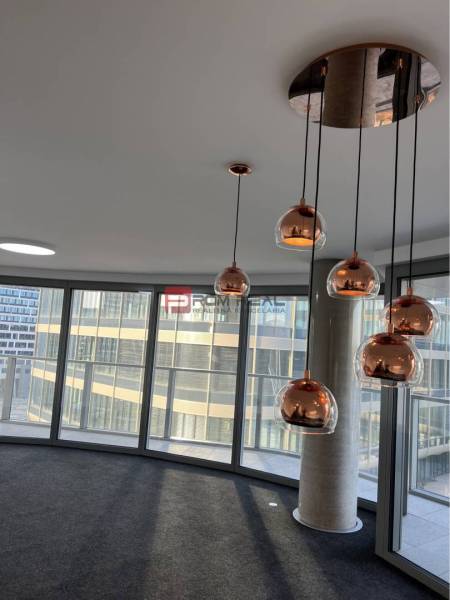 Commercial spaces with glass walls and pendant lights that create a pleasant atmosphere.