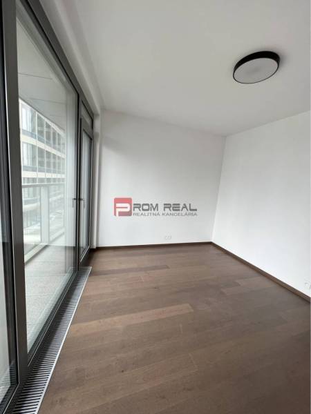 Interior with wooden flooring and large windows in commercial spaces.