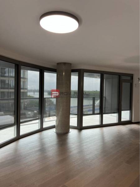 Interior of commercial spaces with large windows and wooden flooring.