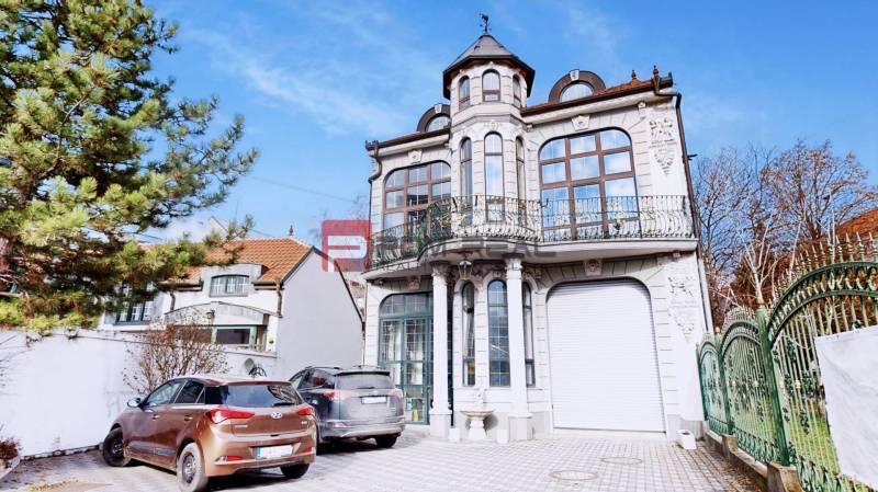 The building on Ľ. Podjavorinská Street in Trnava with an ornate balcony and decorative facade.