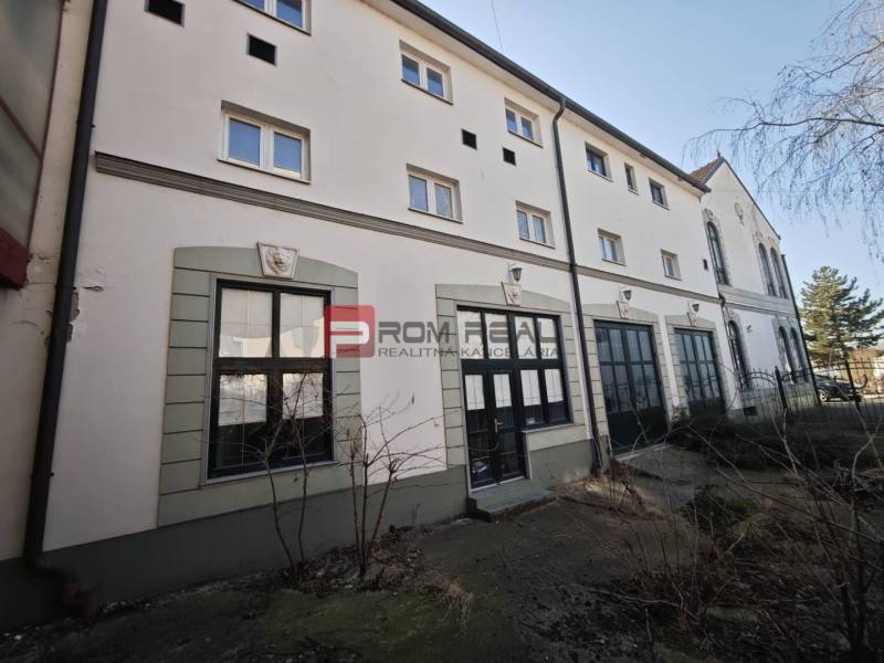 On Ľ. Podjavorinská Street, there is a building with large windows and historical details.
