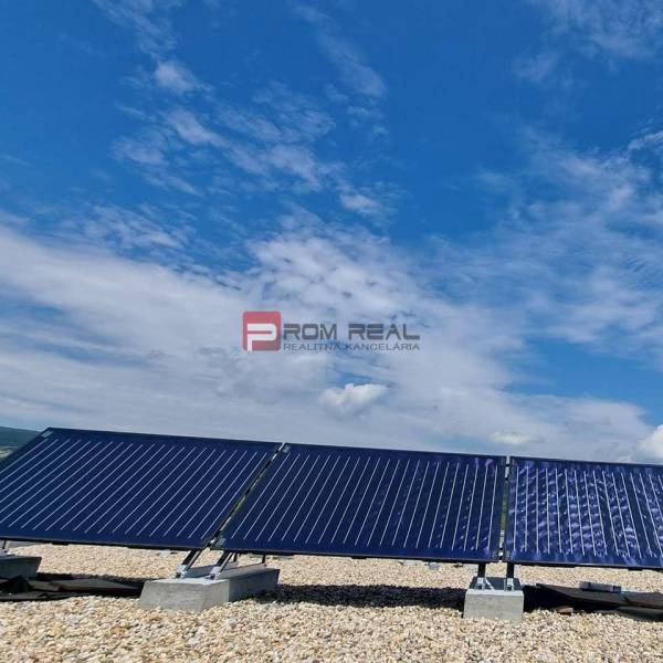 Solar panels against a blue sky. On Pezinok street, a 2-room apartment is waiting for a new owner.