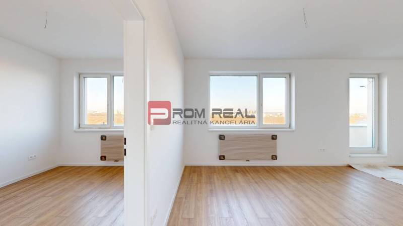 A bright interior of a 2-room apartment with wooden flooring and windows.