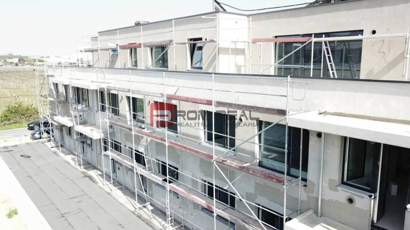 A building on Limbašská Street in Pezinok during the construction of 3-room apartments with scaffolding.
