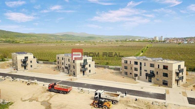 On Limbašská Road, there are new buildings surrounded by vineyards near two 2-room apartments.