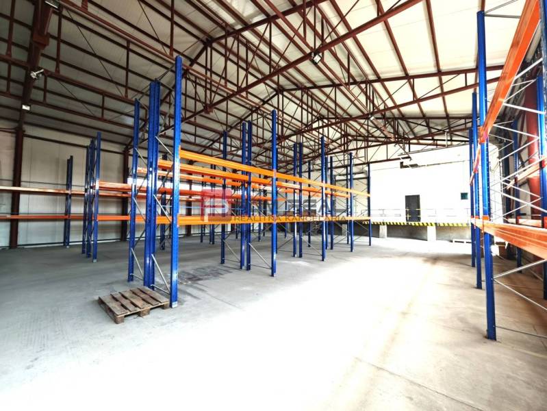 In warehouses and halls, there are empty shelves and a pallet on the floor.