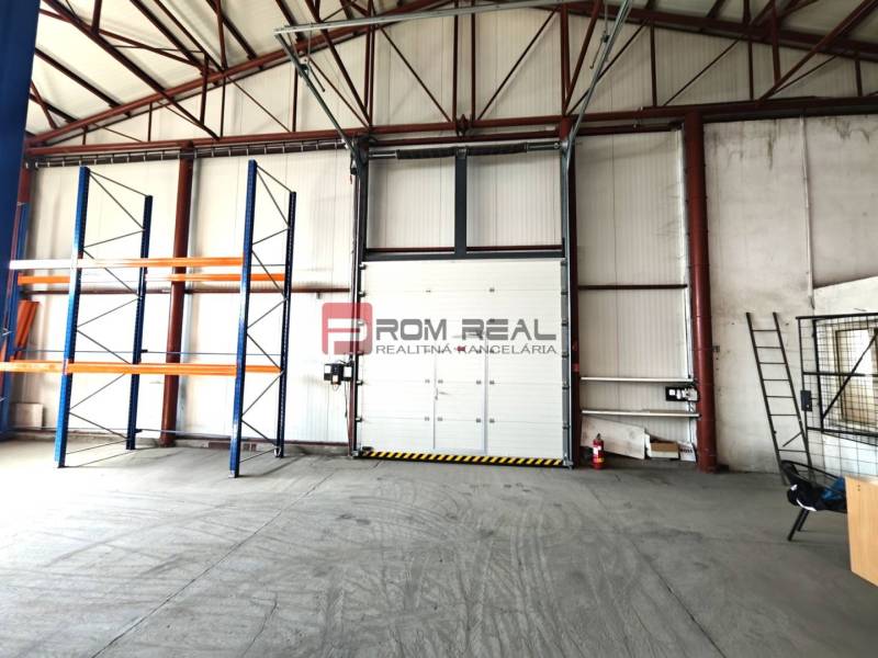 Warehouses and halls with shelves and a garage door, empty space ready for use.
