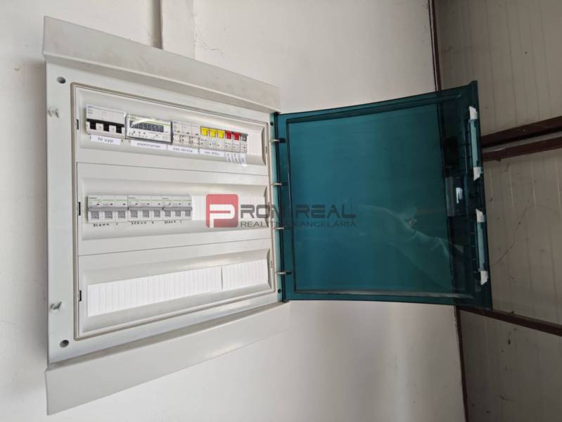 Electrical distribution cabinet in the warehouse and hall areas with an open cover.