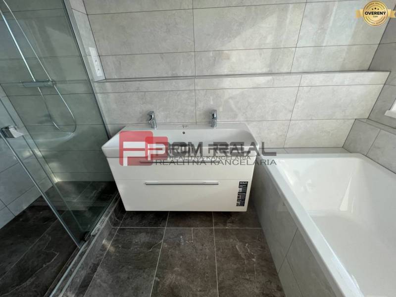 A bathroom with a bathtub and a shower in a 4-room apartment.
