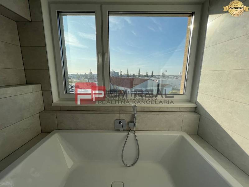 A bathroom with a bathtub and a window in a 4-room apartment.