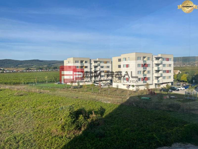 Apartment buildings on Obchodná Street in Pezinok with a view of the surrounding nature.