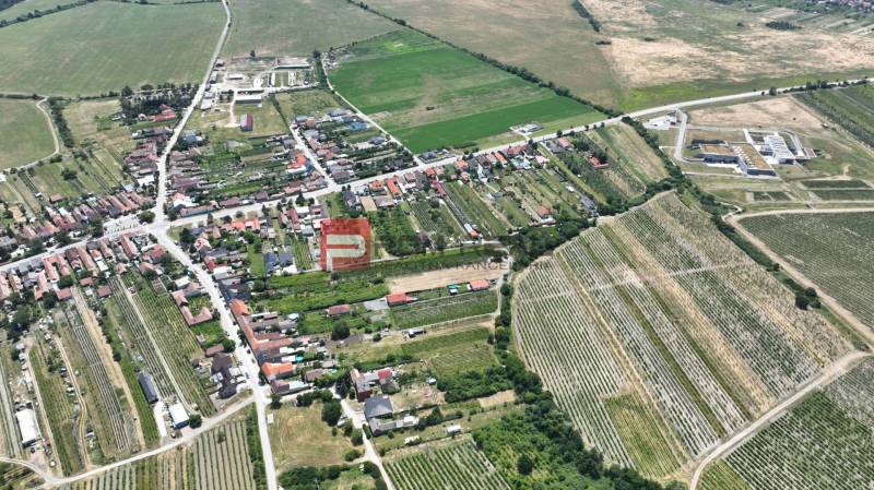 Aerial view of Dubová, organized streets and surrounding fields, plots - housing.