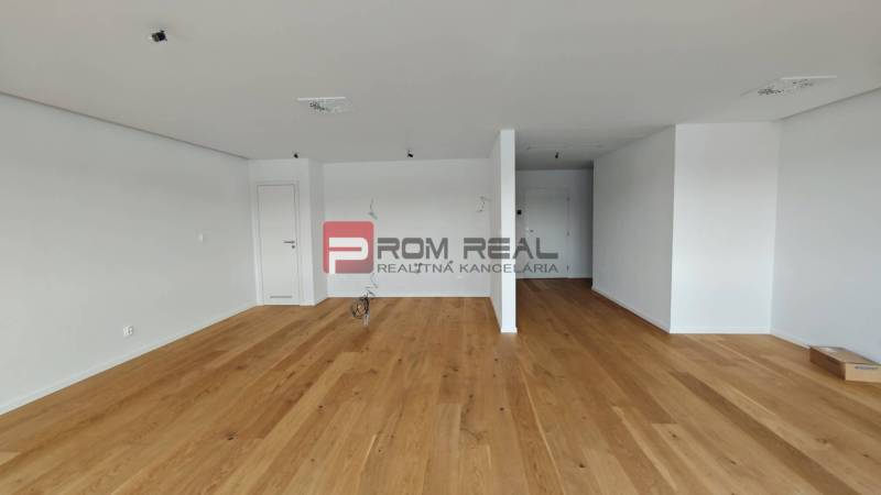 A spacious room with a wooden floor in a 4-room apartment, ready to be furnished.