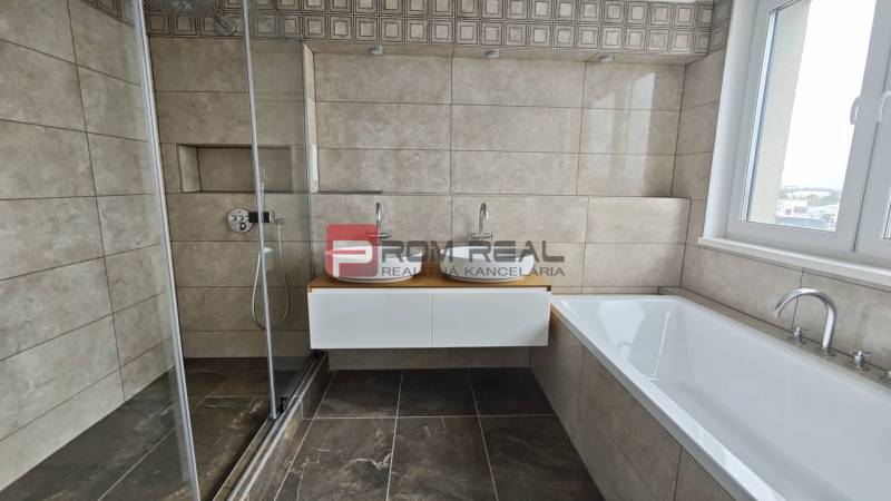 A bathroom in a 4-room apartment with a shower, bathtub, and double sink.