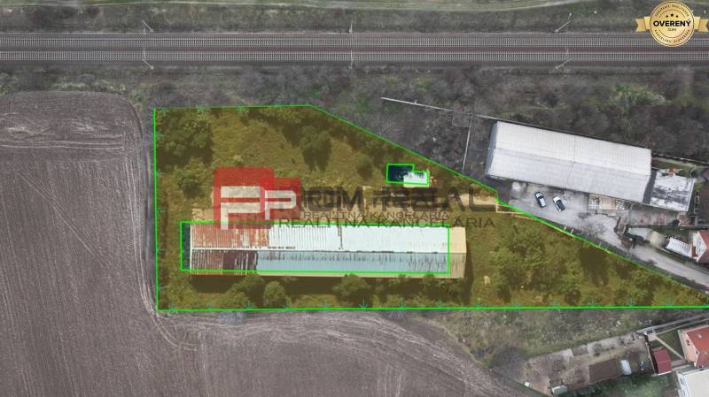 The area on Partizánska Street contains warehouses, halls, near the railway track.