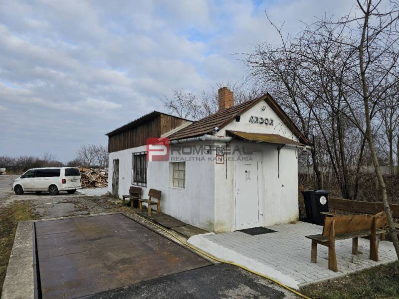 On Partizánska Street, in front of the building with the sign ARDOR, there are barrels and halls.