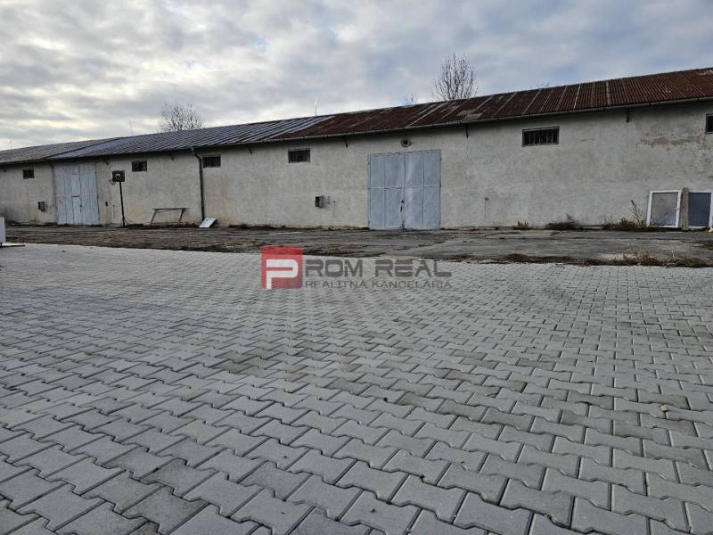 The exterior of an industrial building on Partizánska Street, warehouses and halls on the pavement.