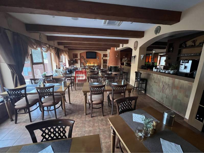 Restaurant in the hotel area with wooden beams, tables, and chairs. Hotels and guesthouses.