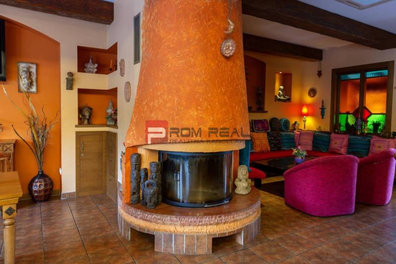 Interior with a fireplace, comfortable seating, and decorations in hotels and guesthouses.