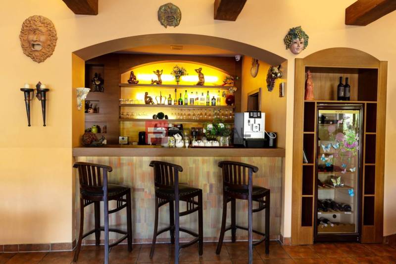 A bar counter with three stools and decorations in the interior of hotels and guesthouses.