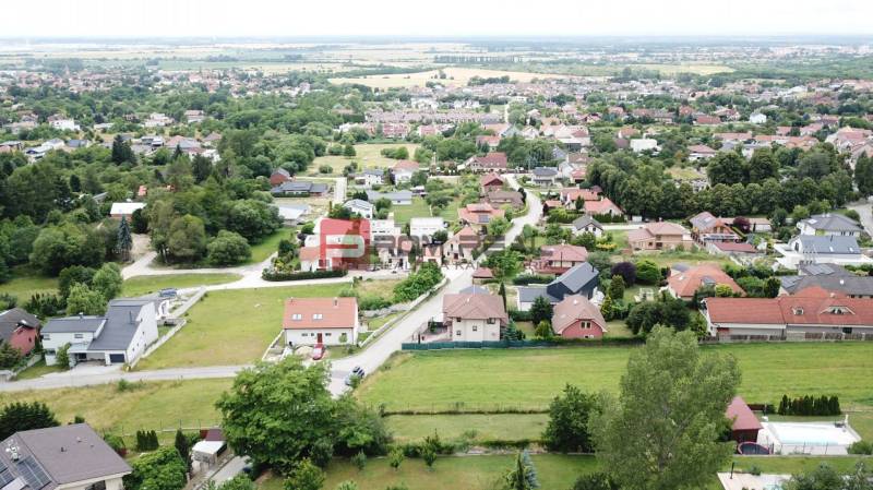 Aerial view of houses and greenery in the village of Marianka on Na Tálkoch street. Residential plots.