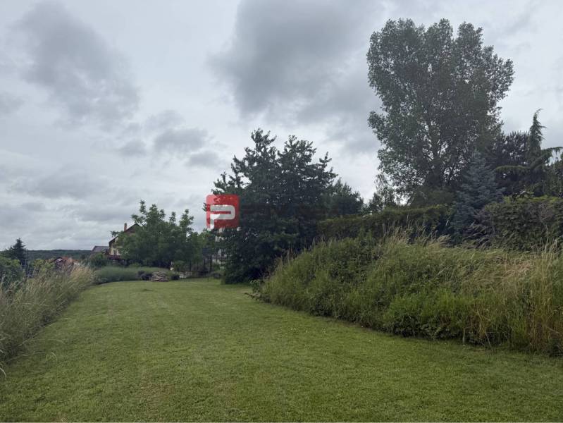 A grassy plot surrounded by greenery in Marianka on Na Tálkoch, ideal for living.