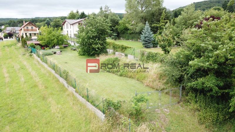 Plots - housing on Na Tálkoch Street in Marianka, surrounded by greenery and houses.