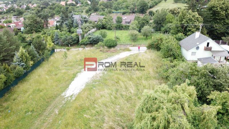 Residential plots in Marianka on Štúrova Street, surrounded by greenery and houses.