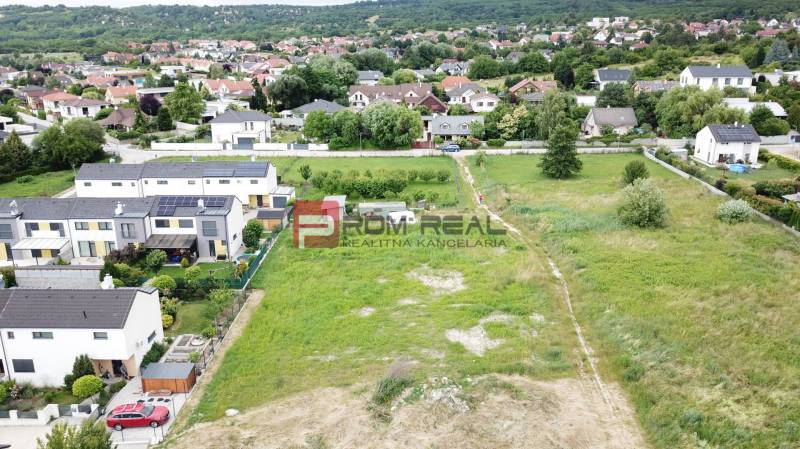 Residential plots in Marianka on Na Ovsisku Street, surrounded by green gardens and houses.