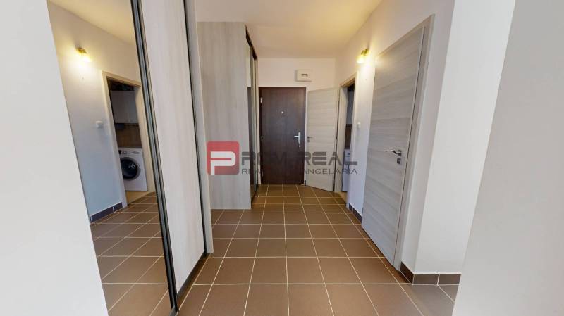 Entrance hall in a 3-room apartment with tiles and a built-in wardrobe.