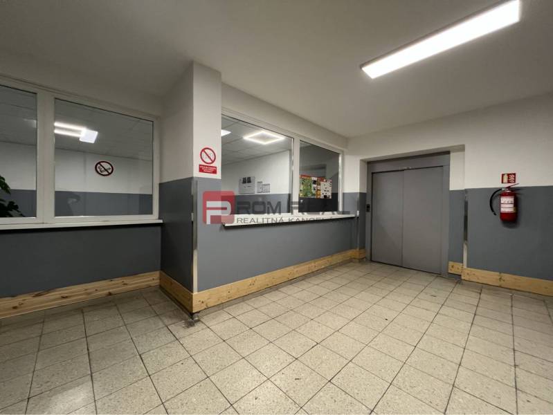 Interiors of warehouses and halls with fire protection equipment, windows, and an elevator.