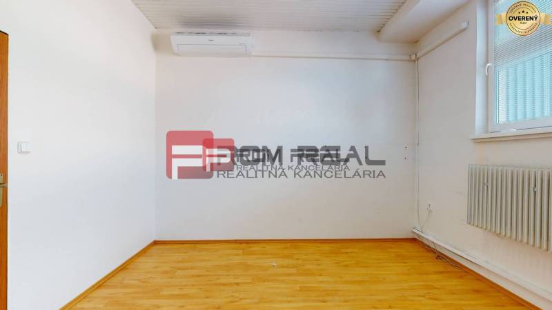 Empty room with light walls, wooden floor, radiator, and air conditioning. Warehouses and halls.