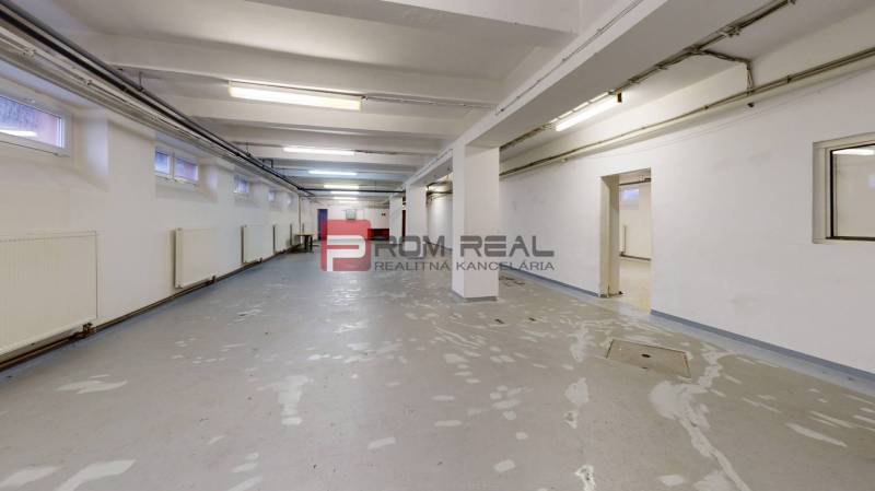 Spacious warehouses and halls with lighting and heating, suitable for rent or storage.