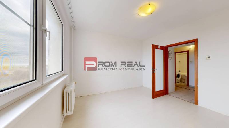 A bright room in a 4-room apartment with large windows and built-in lighting.