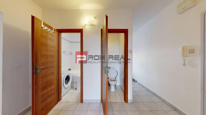 A hallway with doors to the bathroom and toilet in a 4-room apartment.