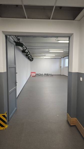 Empty room with gray walls and floor, lighting and ventilation duct in the warehouse and hall.
